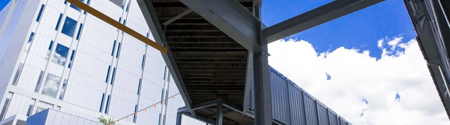 La passerelle couverte de l’hôpital est fabriquée à partir de longs conteneurs d’expédition, offrant un accès protégé entre les bâtiments pour le personnel et les patients.