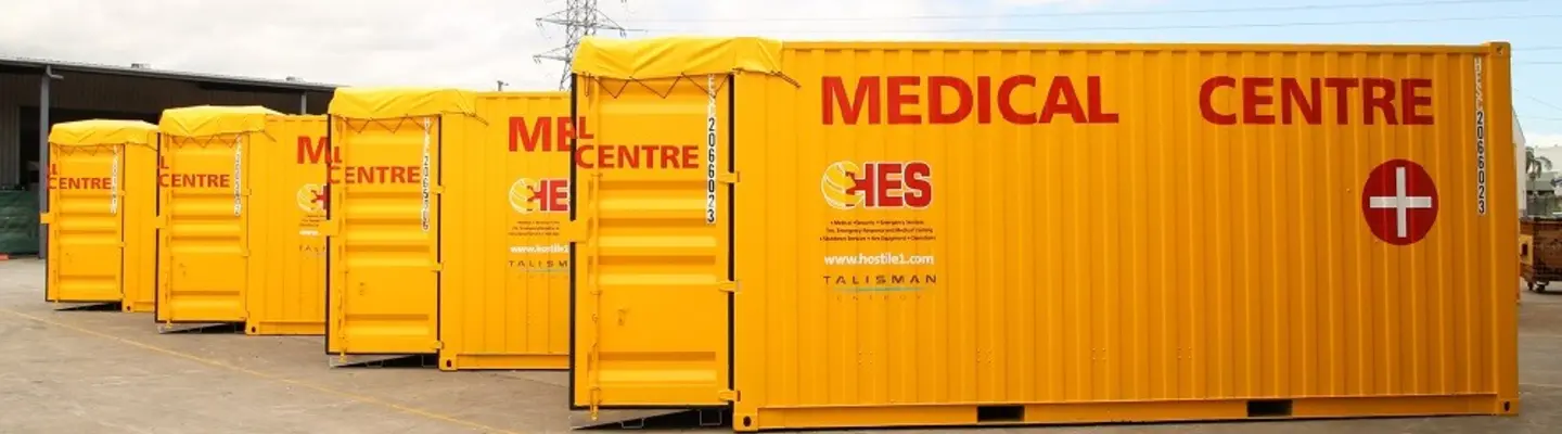 Conteneurs de stockage empilés sur un chantier de construction ou de logistique, organisés et prêts à être déployés ou réutilisés.