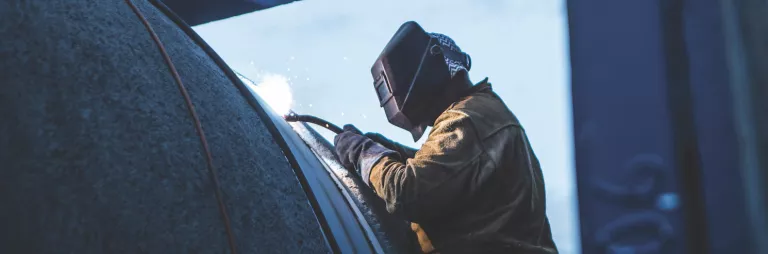welder in trench