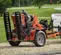 Remorque Ditch Witch orange pour trancheuse à conducteur accompagnant avec rampe verticale