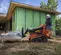 Chargeuse à chenilles compacte DITCHWITCH rouge, noire et orange de 150 à 180 kg