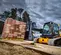 Chargeuse à chenilles compacte JCB jaune et noire de 1 240 kg avec flèche télescopique