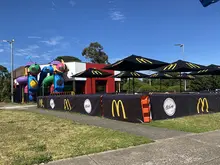 Workers placing safety barriers outside a McDonald’s to guide customers and ensure safe, organized foot traffic flow.