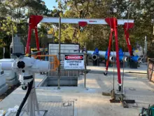 Construction site with various materials scattered and a warning sign indicating a dangerous confined space for safety awareness.